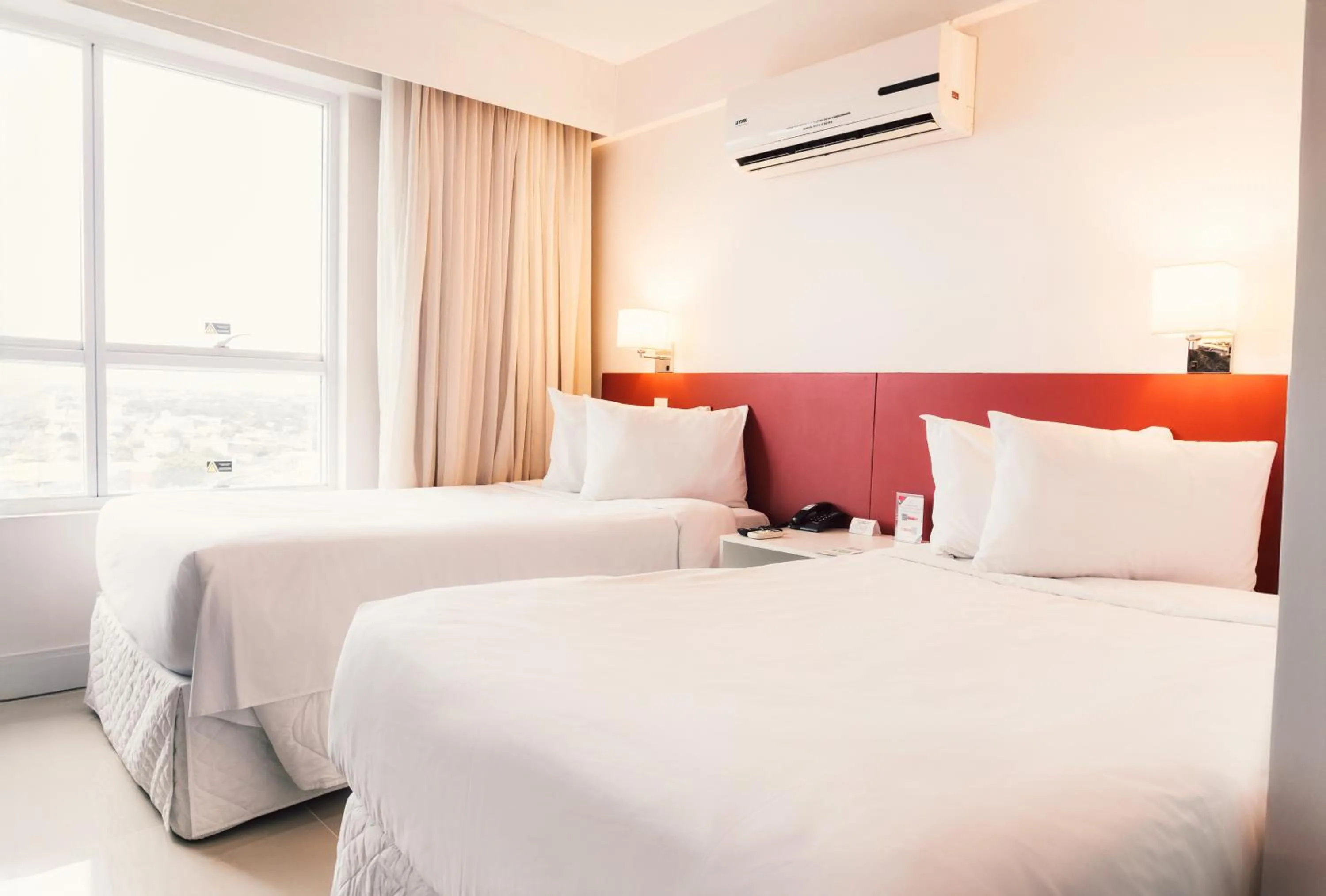 Bed in Ramada Hotel & Suites Campos Pelinca