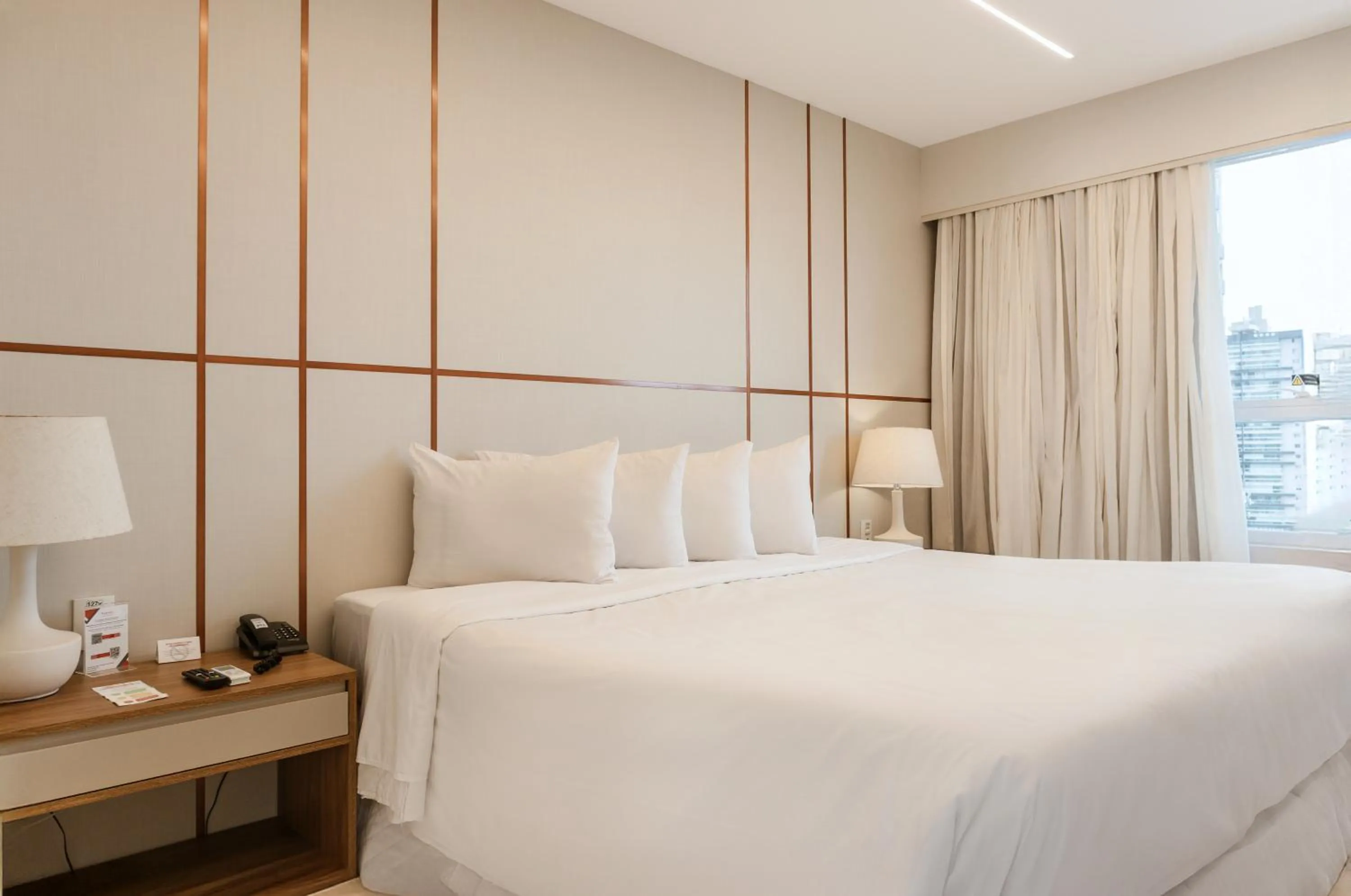 Bed in Ramada Hotel & Suites Campos Pelinca