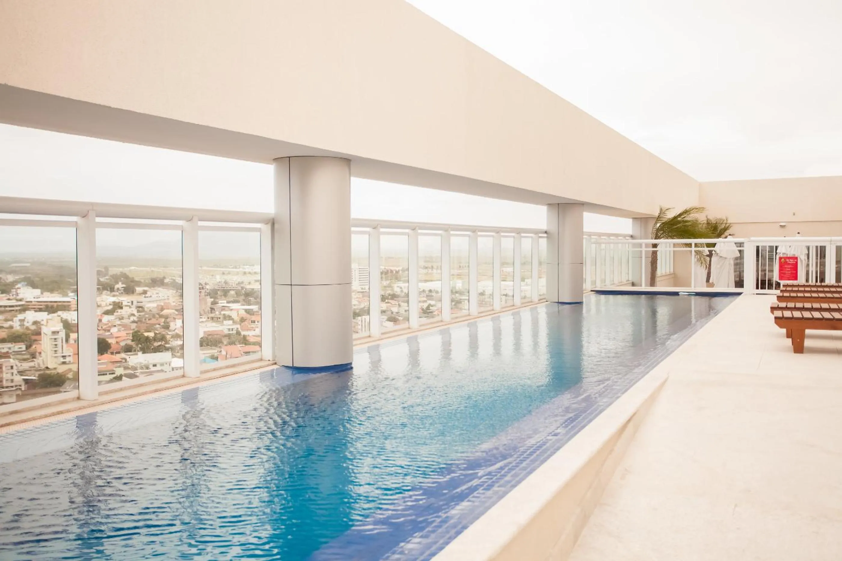 Swimming pool in Ramada Hotel & Suites Campos Pelinca