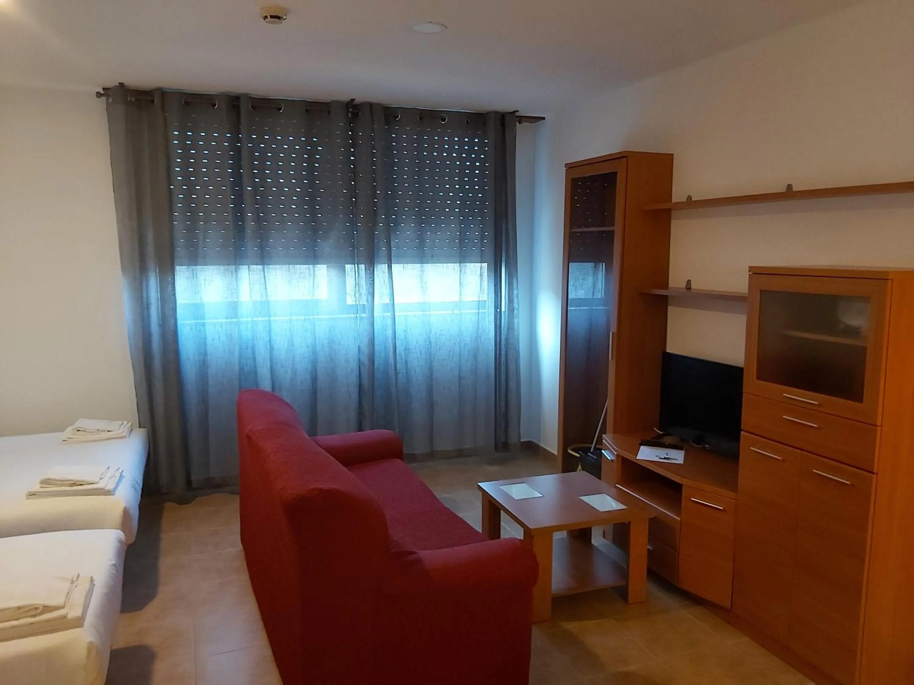 Communal lounge/ TV room, Bed in Apartamentos Turísticos Cancelas by Bossh Hotels