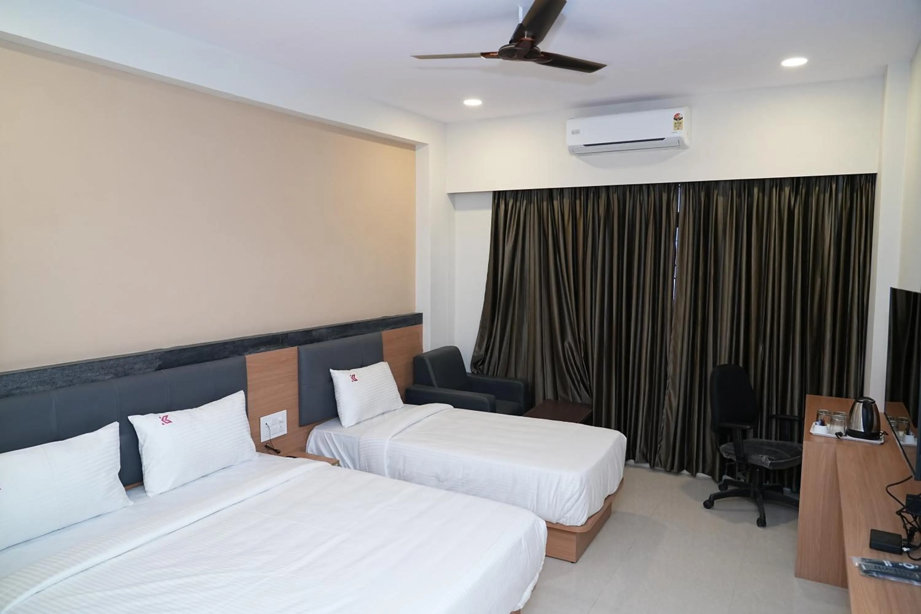 Bed in Hotel Kalyan Suites