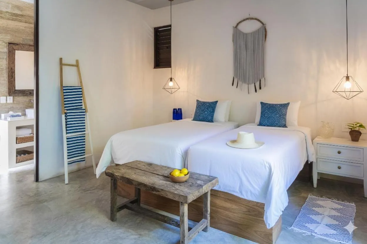 Bed in La Zebra Tulum, a Small Luxury Hotel