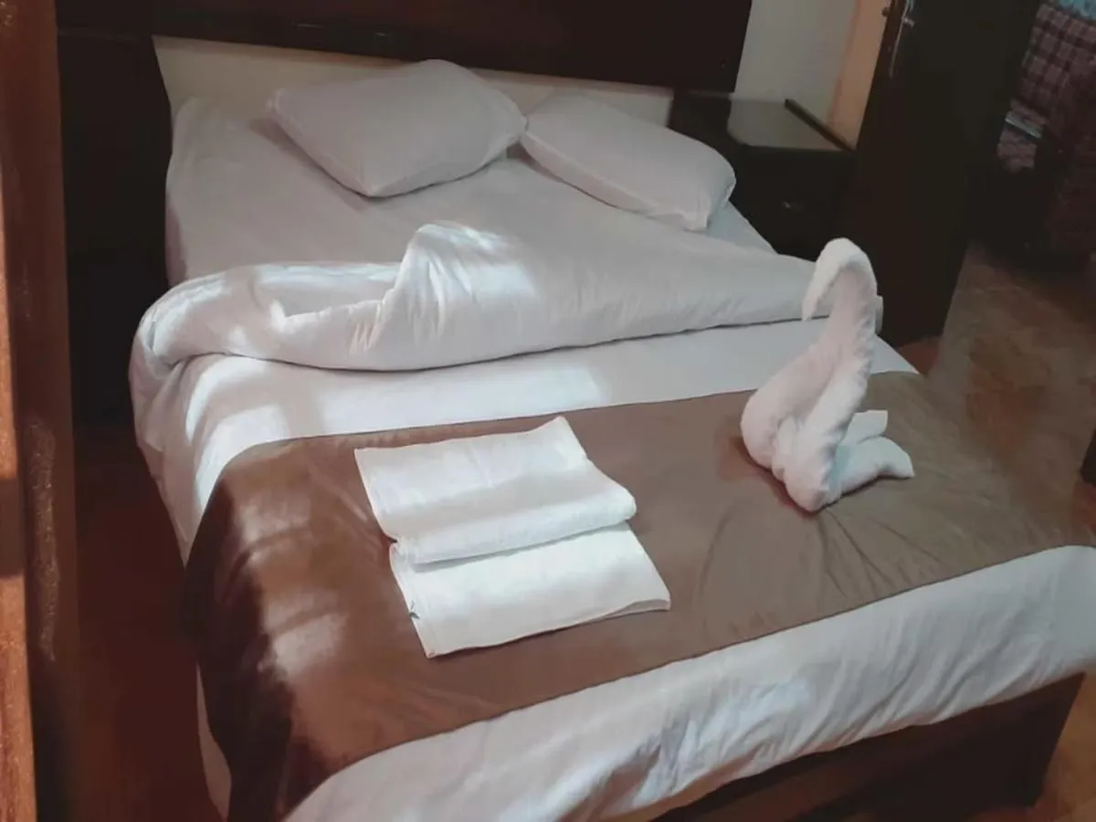 Bed in Al-Nujoom Hotel Suites