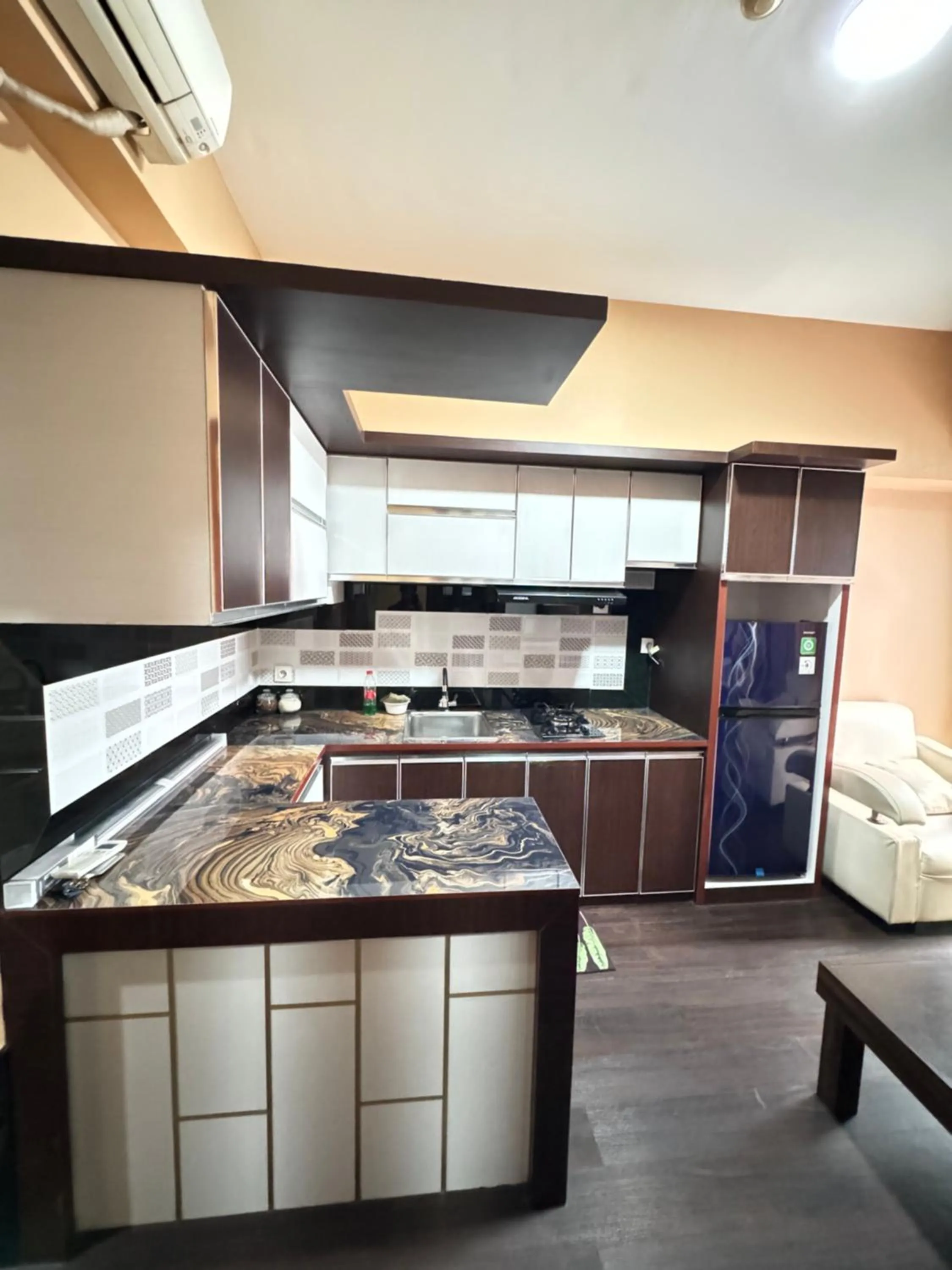 Kitchen or kitchenette in Tmansari Mahogany Apartement By Cozy