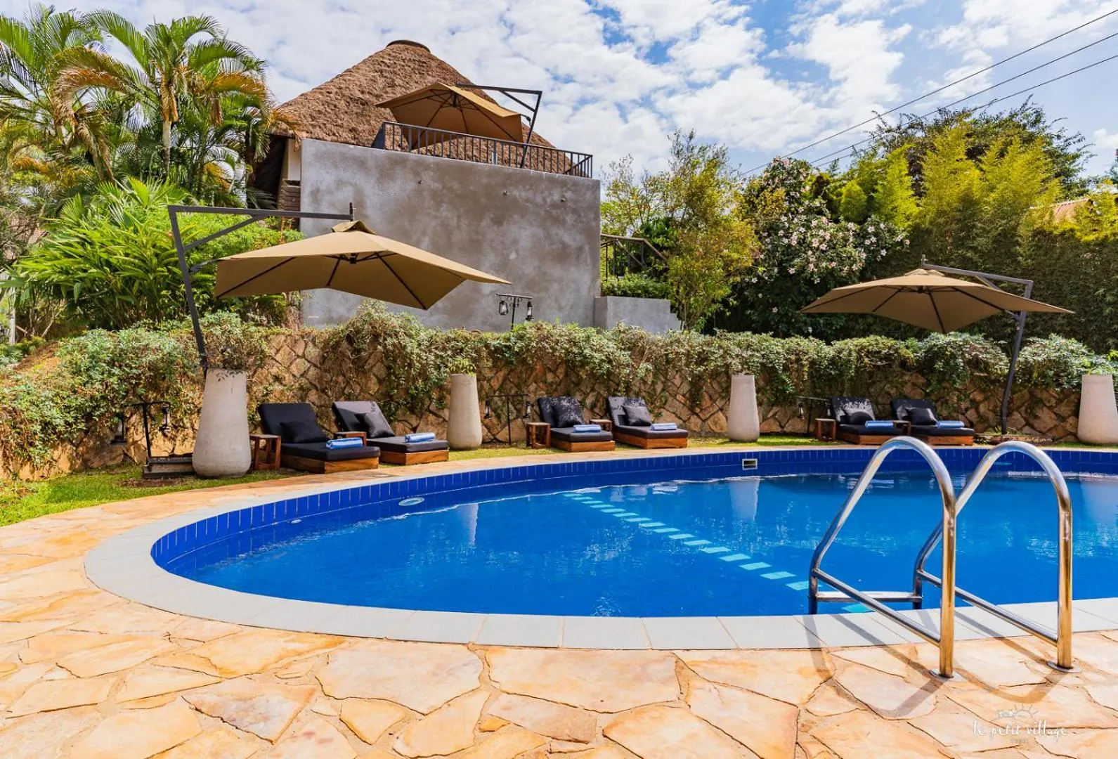 Swimming pool in Le Petit Village Boutique Hotel & Spa