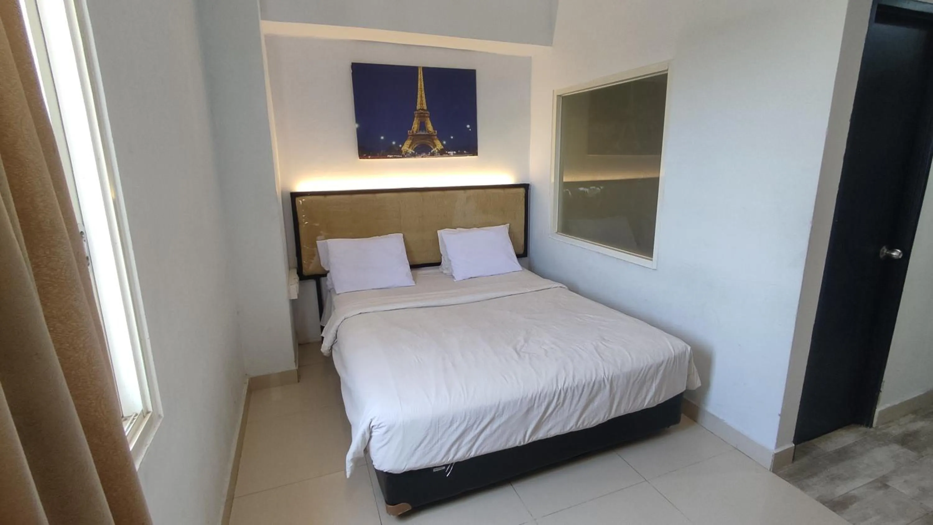 Bed in De La Charis Hotel by Waringin Hospitality