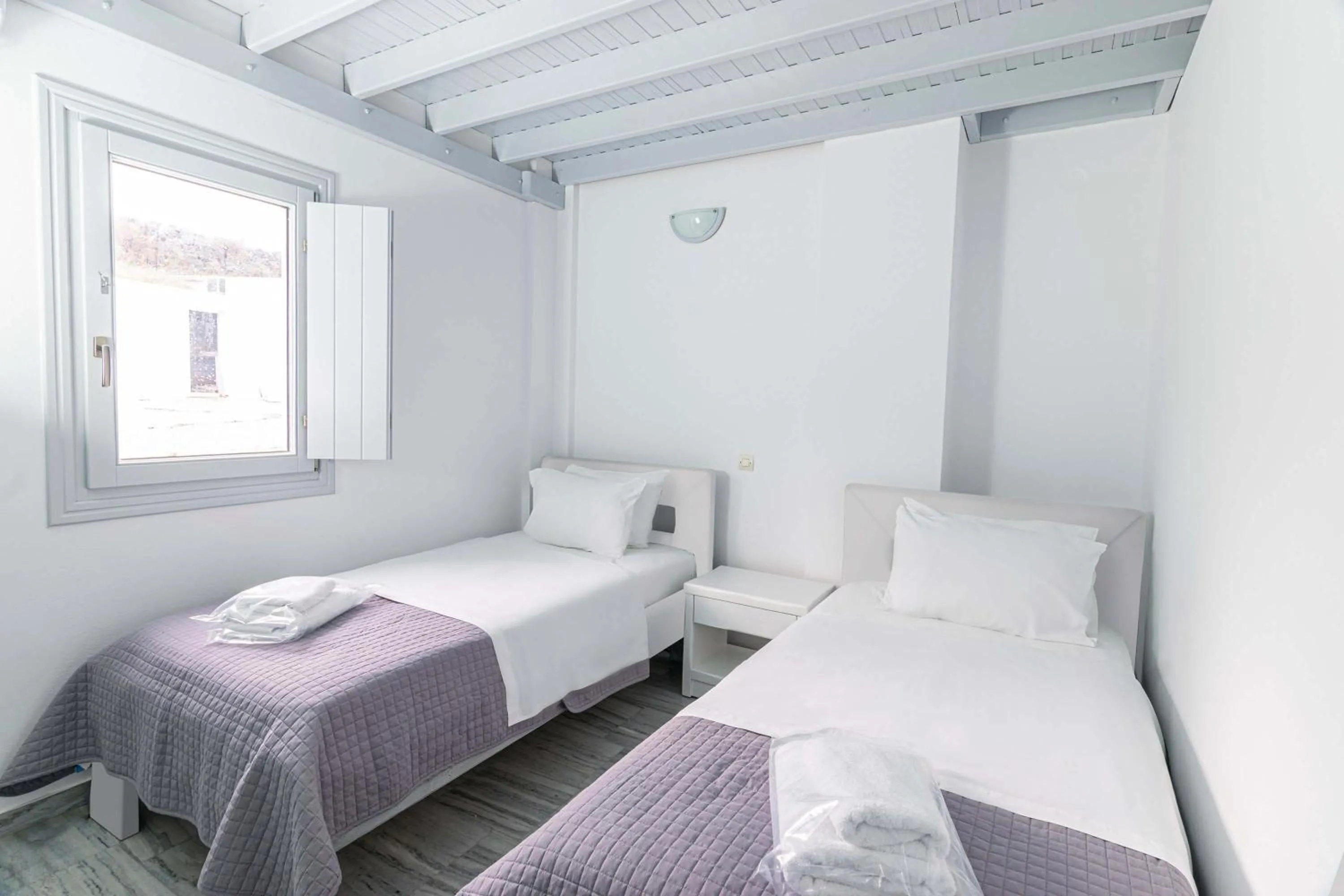 Bed in Phaos Santorini Suites