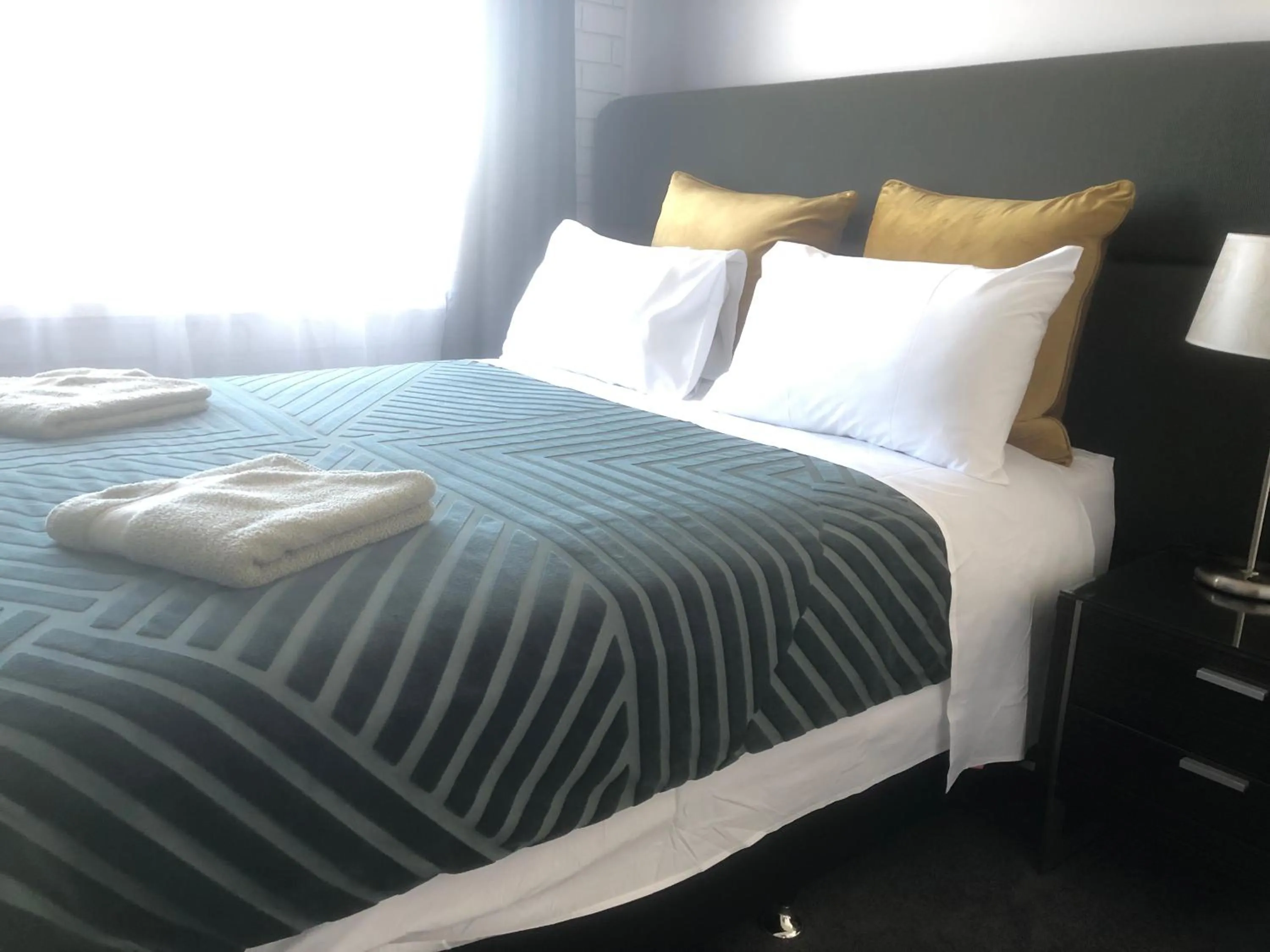 Bed in White Manor Motel