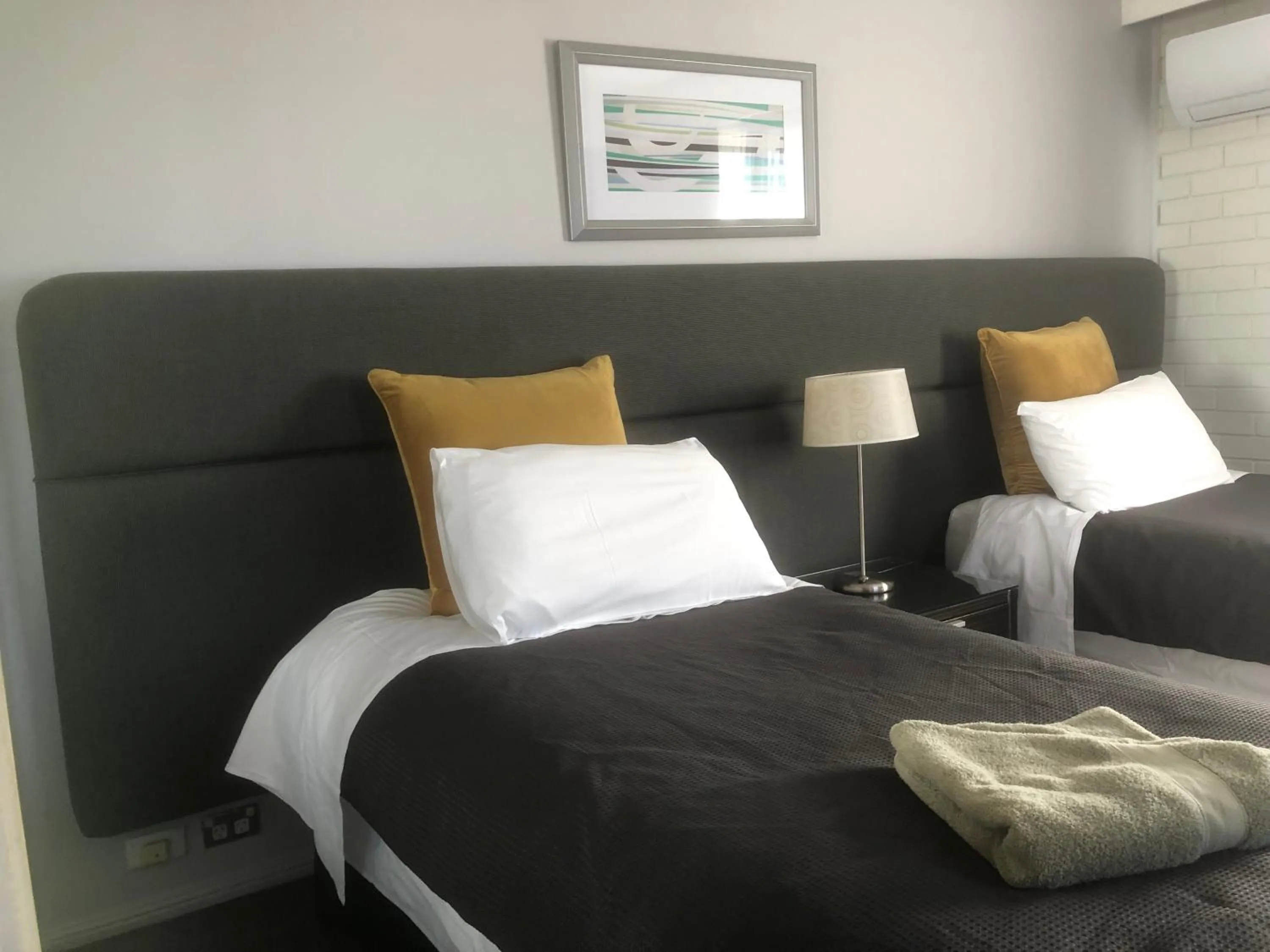 Bed in White Manor Motel