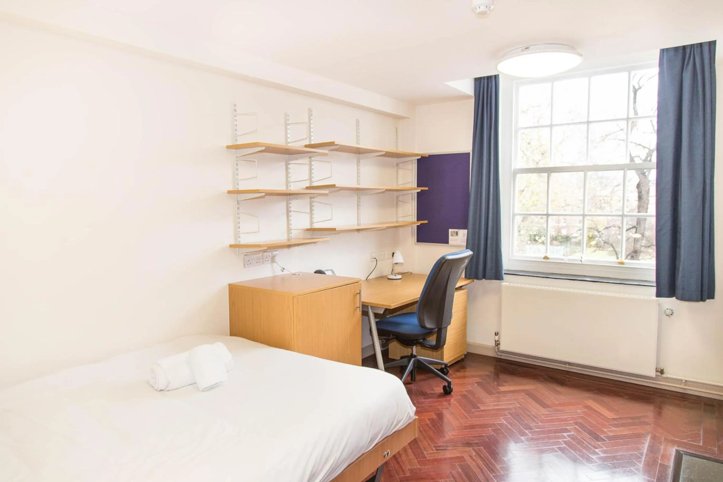 Seating area, Bed in Goodenough College – University Residence