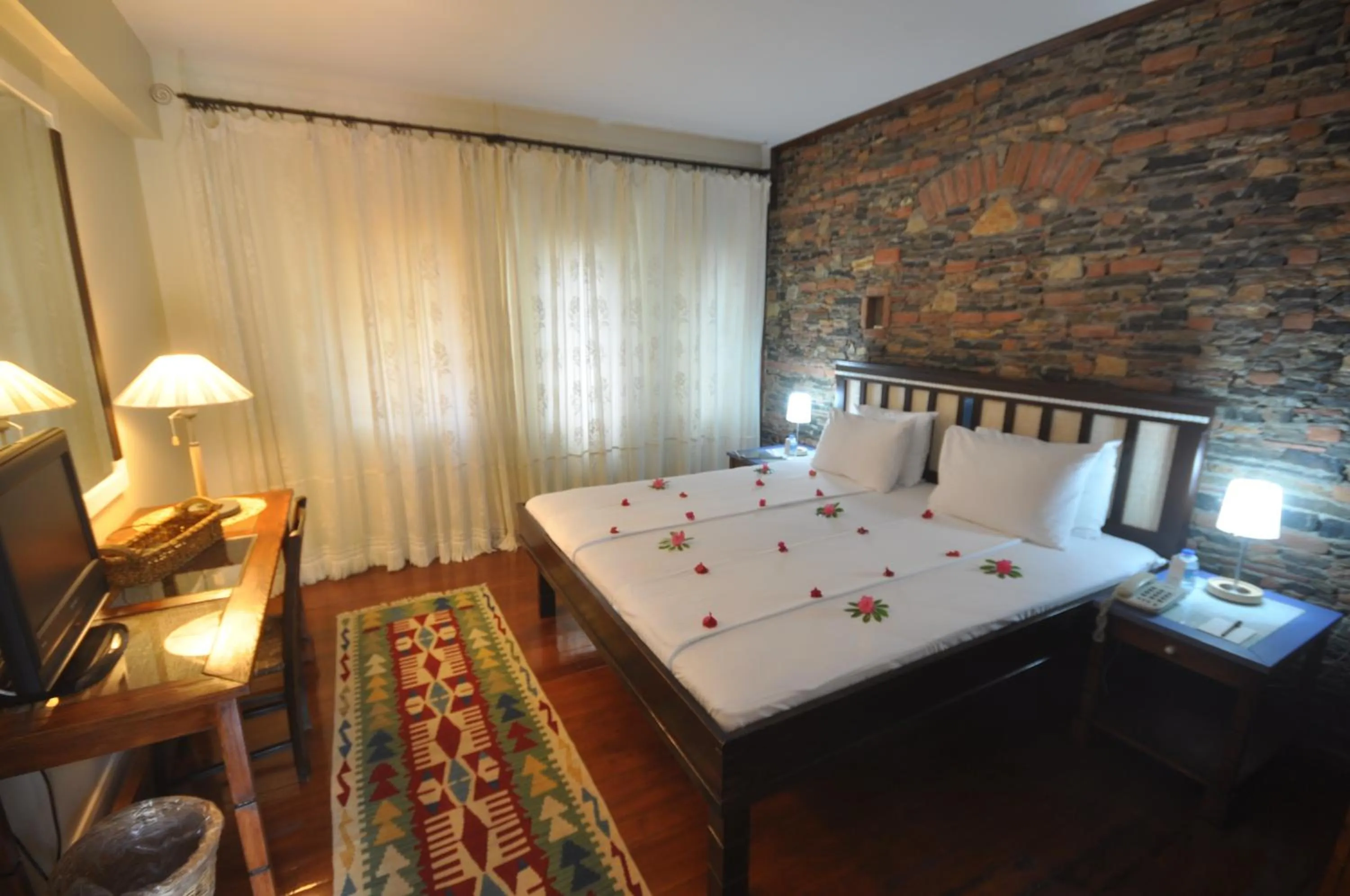 Bed in El Vino Hotel & Suites