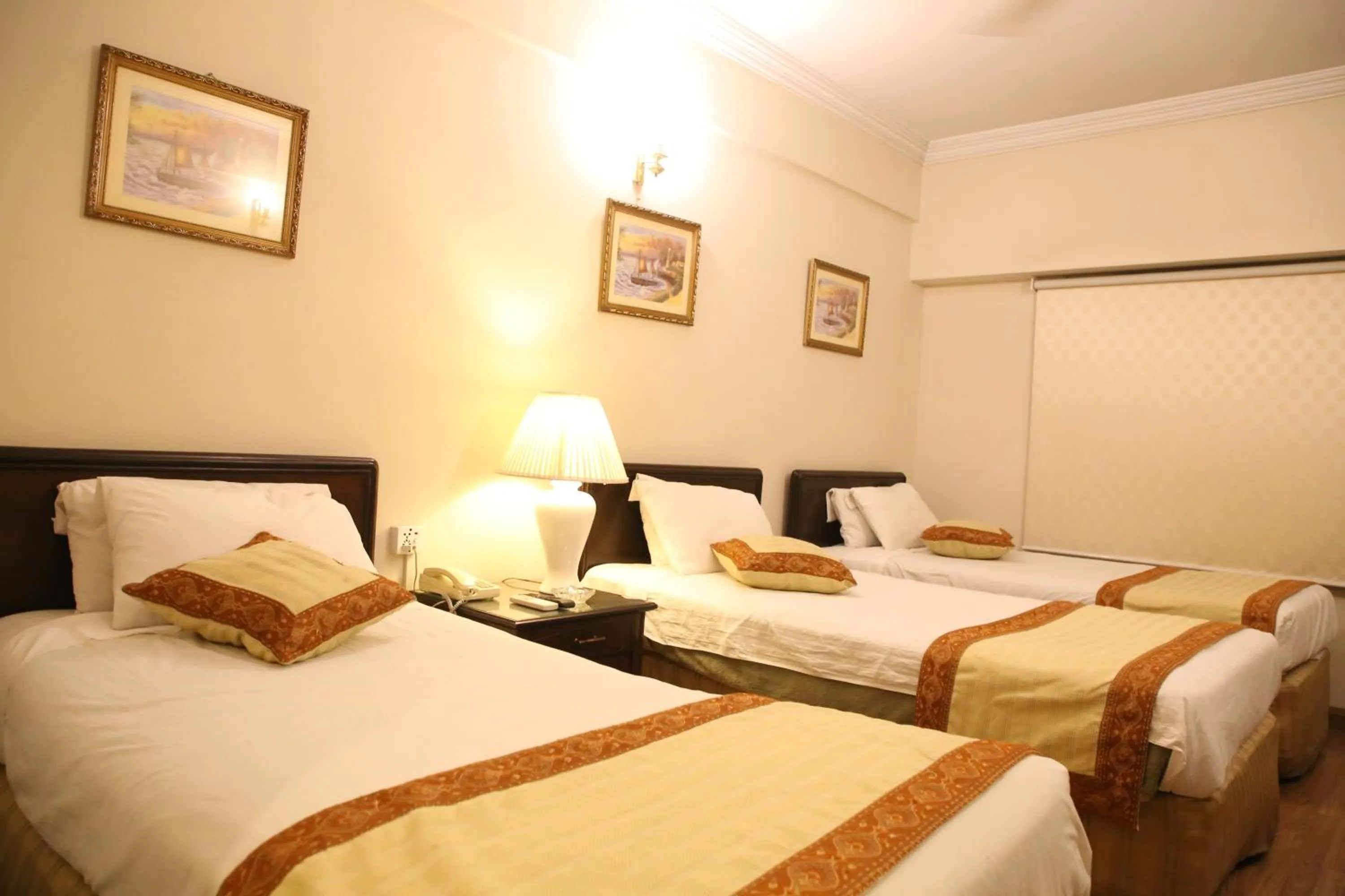 Bed in Carlton Tower Hotel Lahore