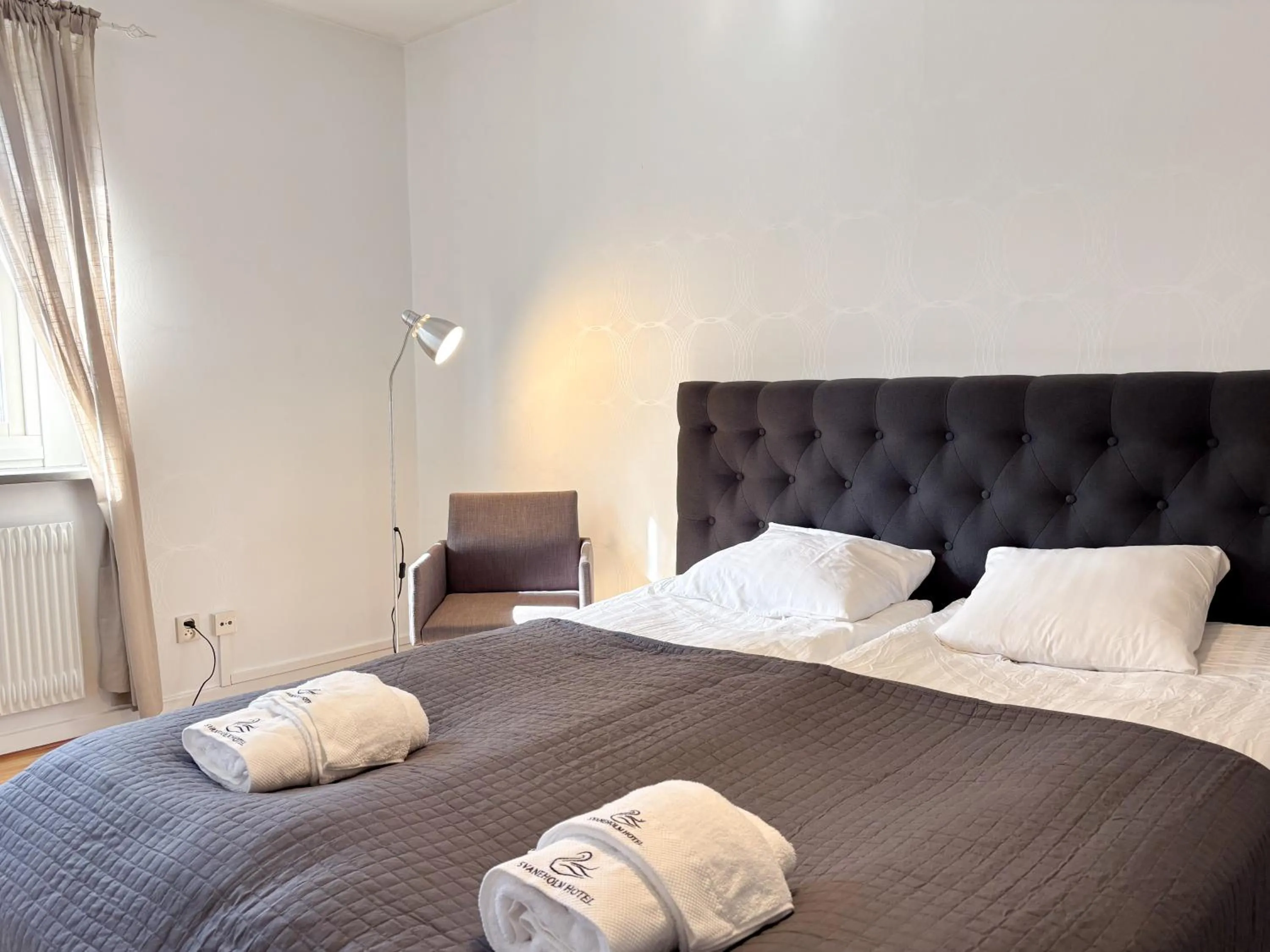 Bed in Säffle Suites by Svaneholm Hotel