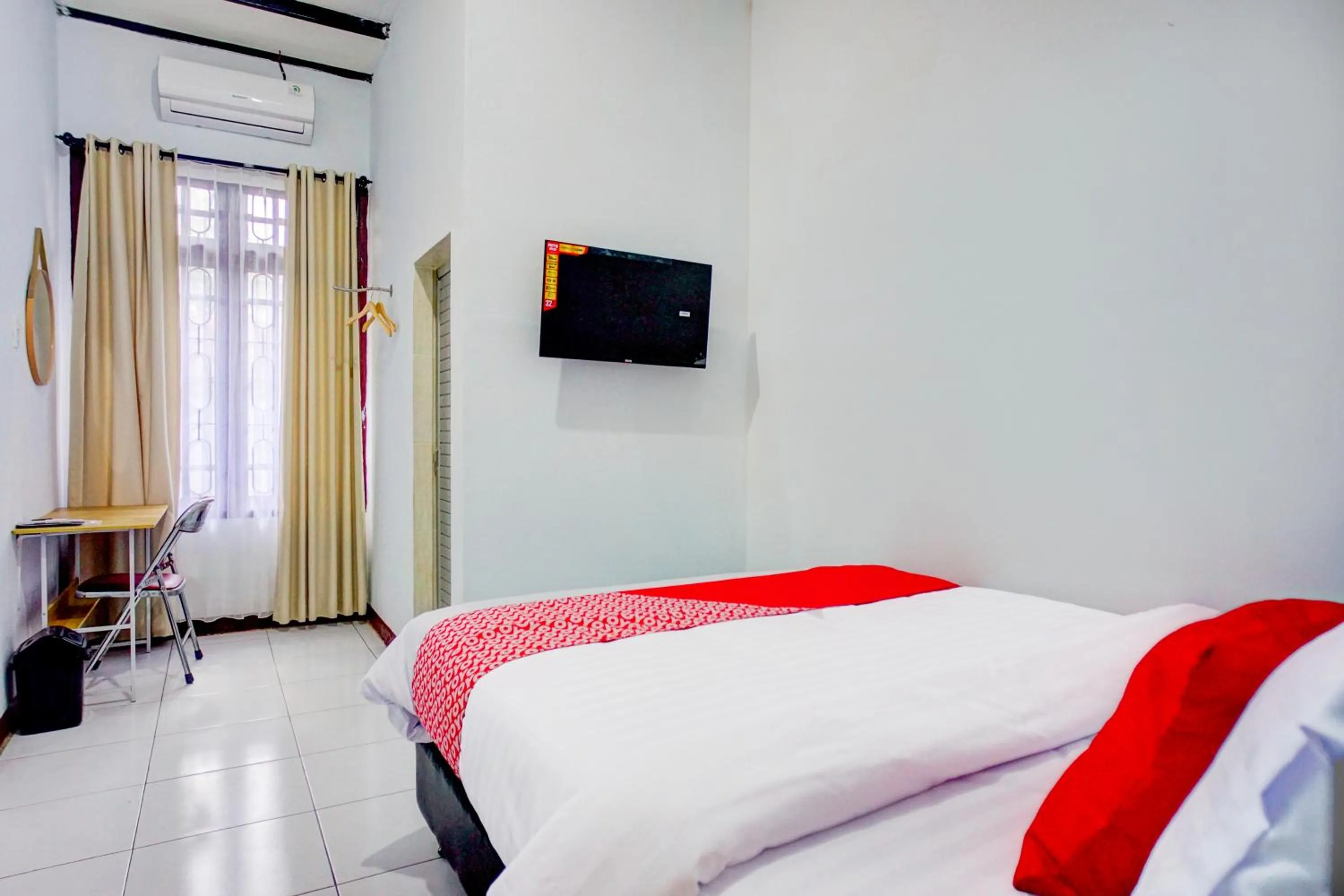 air conditioner, Bed in Hotel O Krakatau Near Universitas Muhammadiya Sumatra Utara ( UMSU )