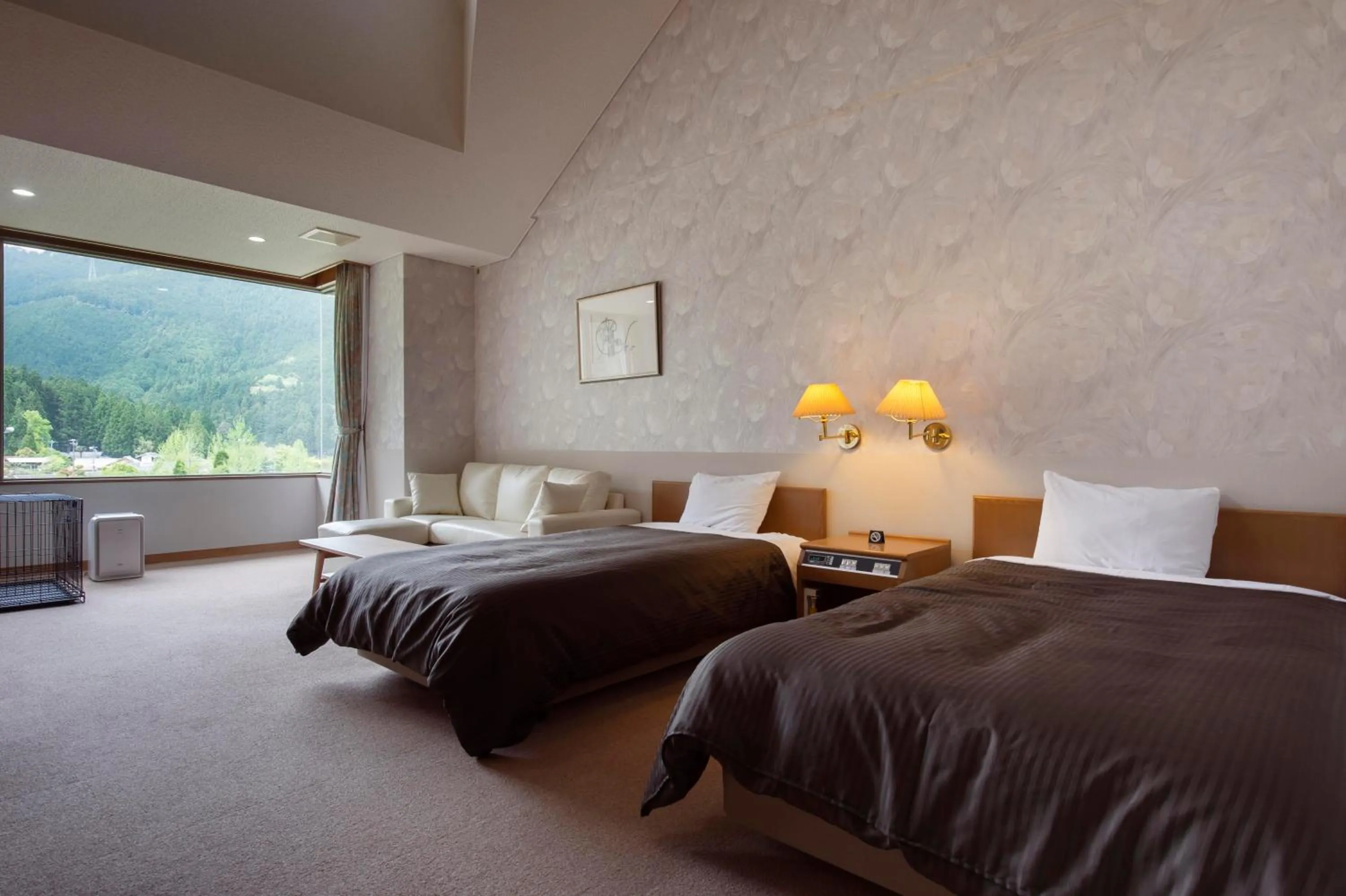 Bed in Matsusaka Wan Wan Paradise Forest Hotel