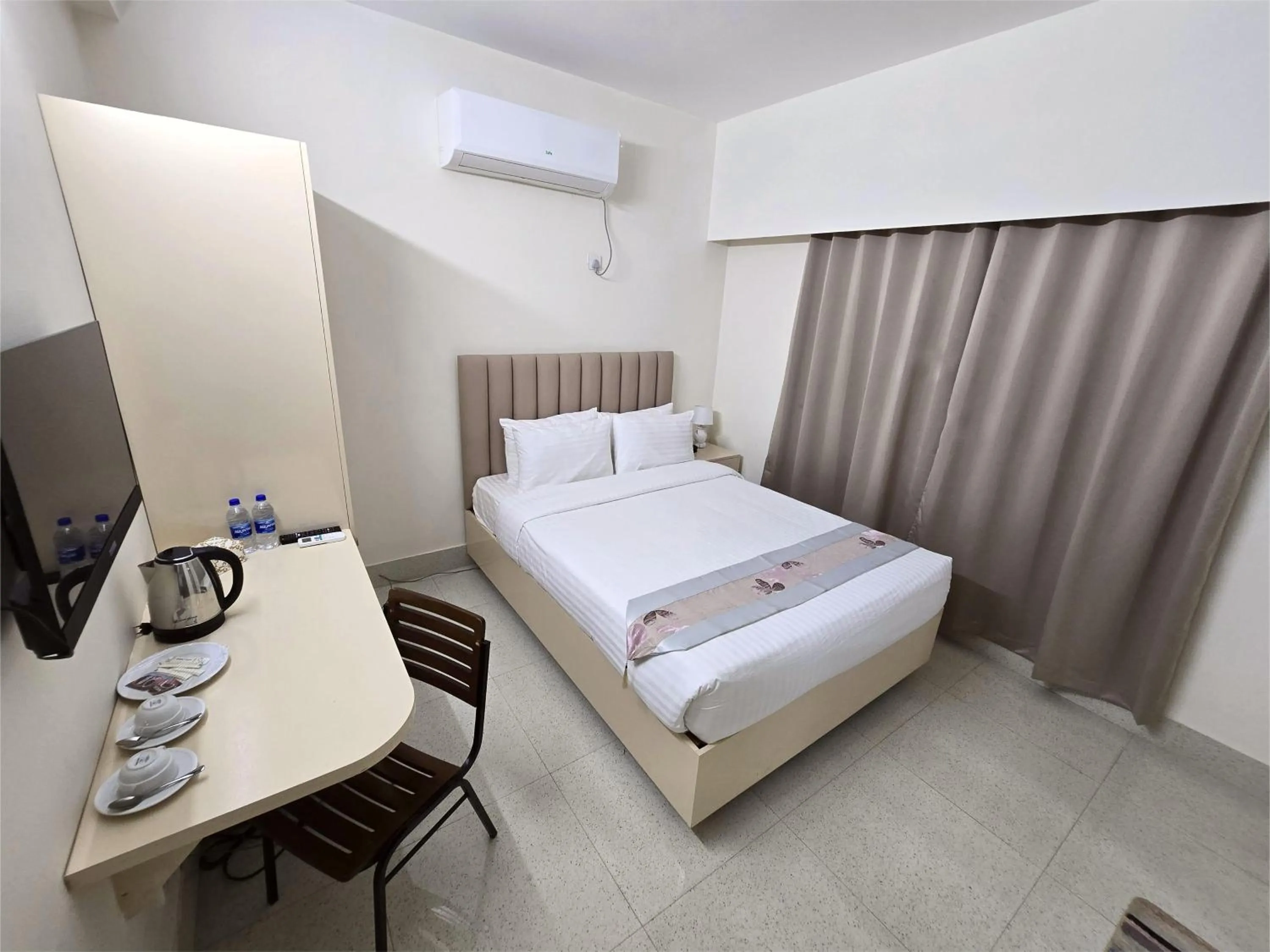 Bed in Royal Regent Suites Dhaka