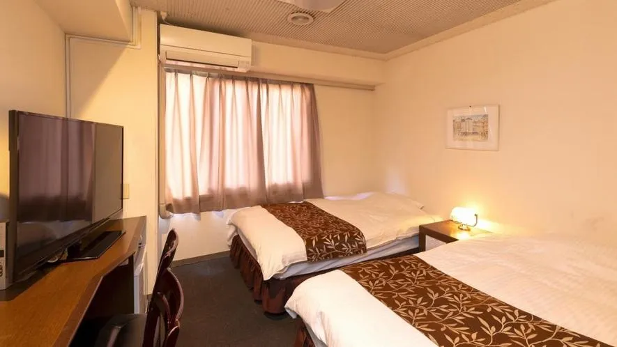 Bed in New Gloria Oita Hotel