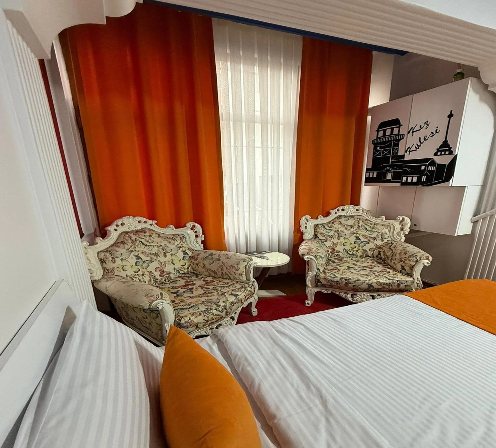 Seating area, Bed in Unique Suite Hotel