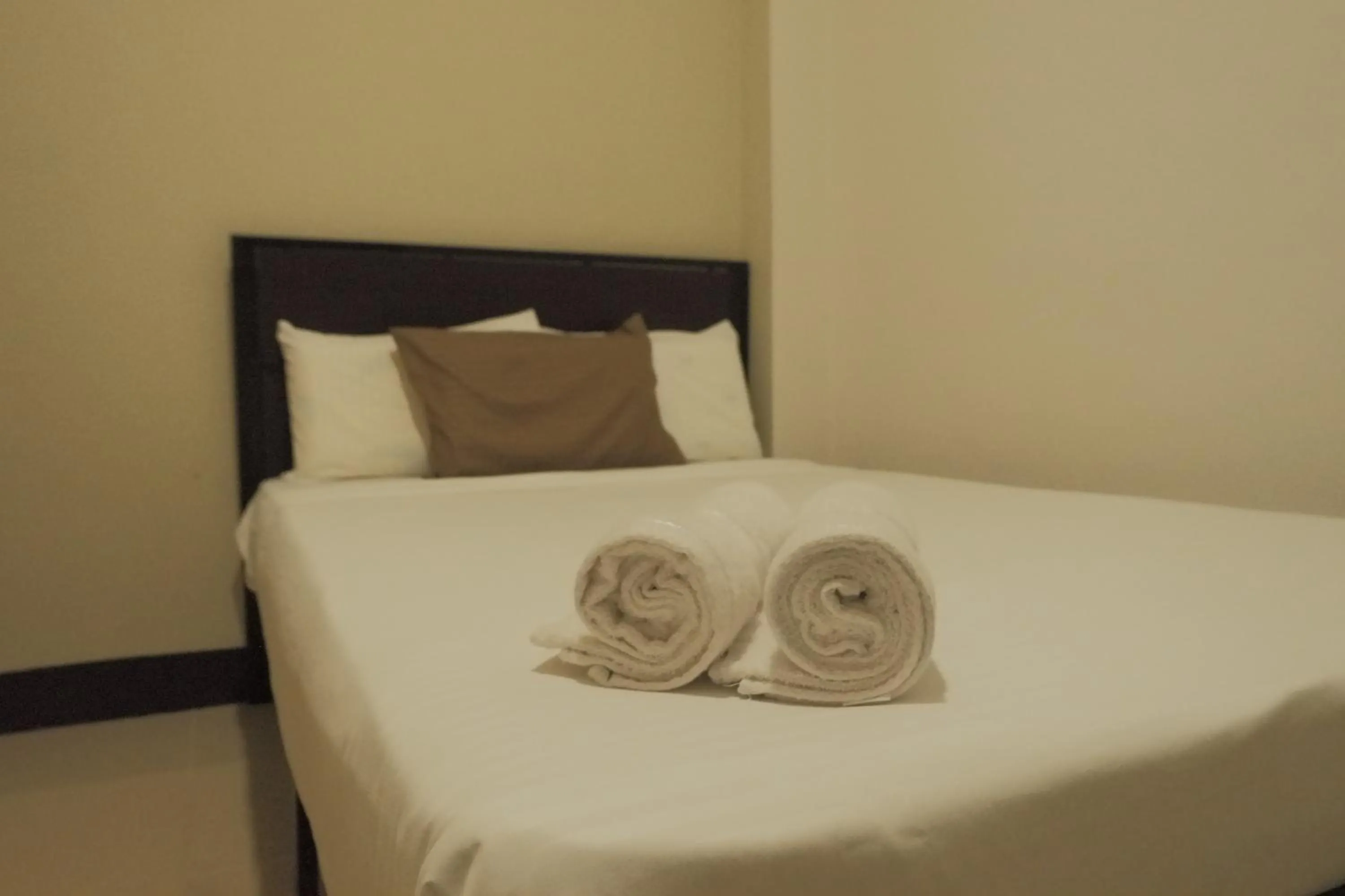 Bed in Brightwood Hotel & Residences