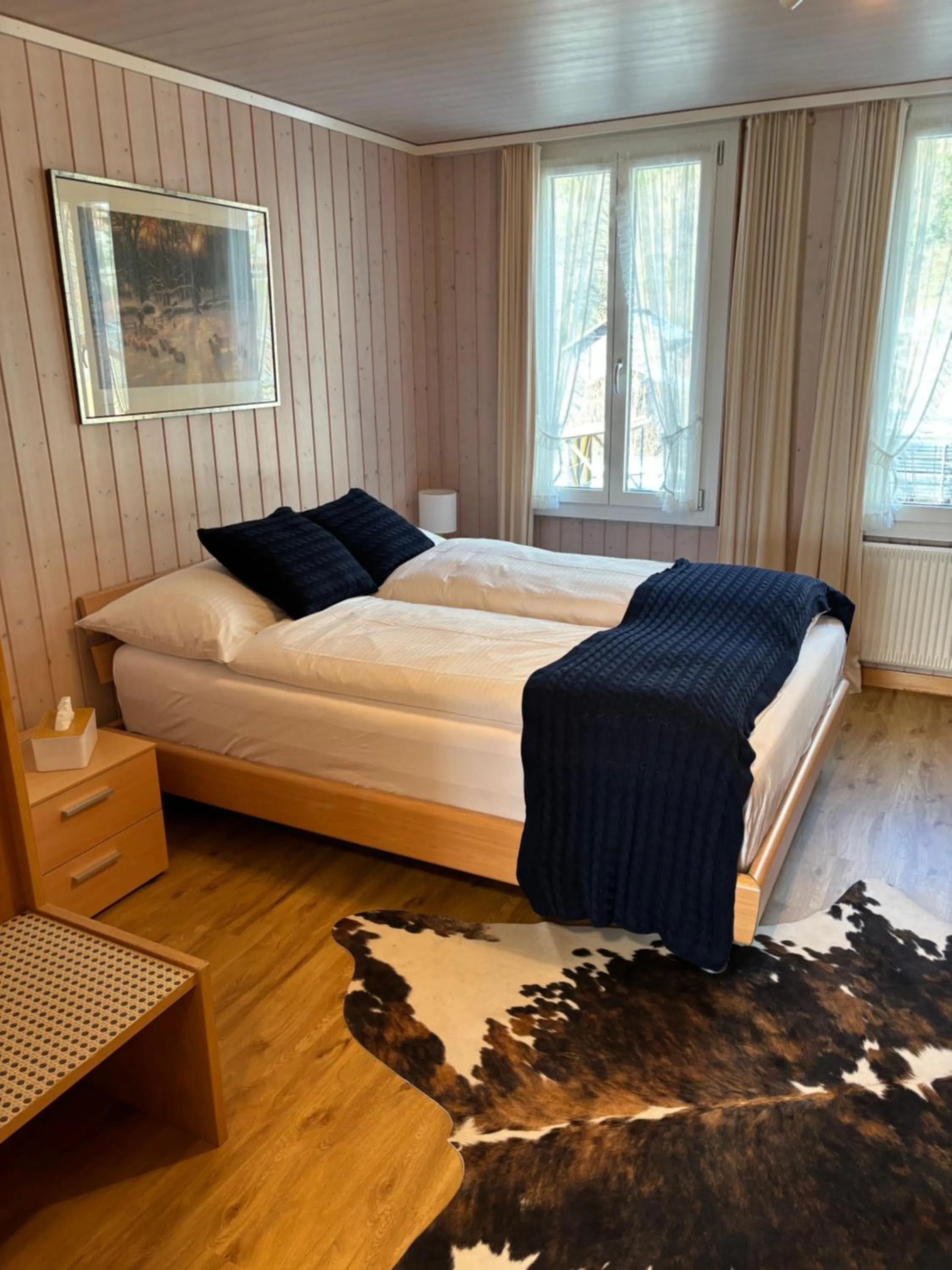 Photo of the whole room, Bed in Alpina Boutique Hotel Interlaken - Ringgenberg - Adults only !