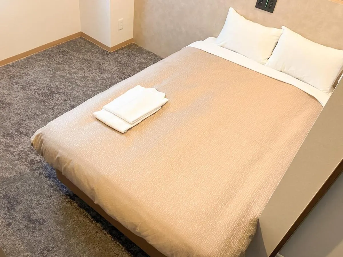 Bed in Hotel LiVEMAX Tendo