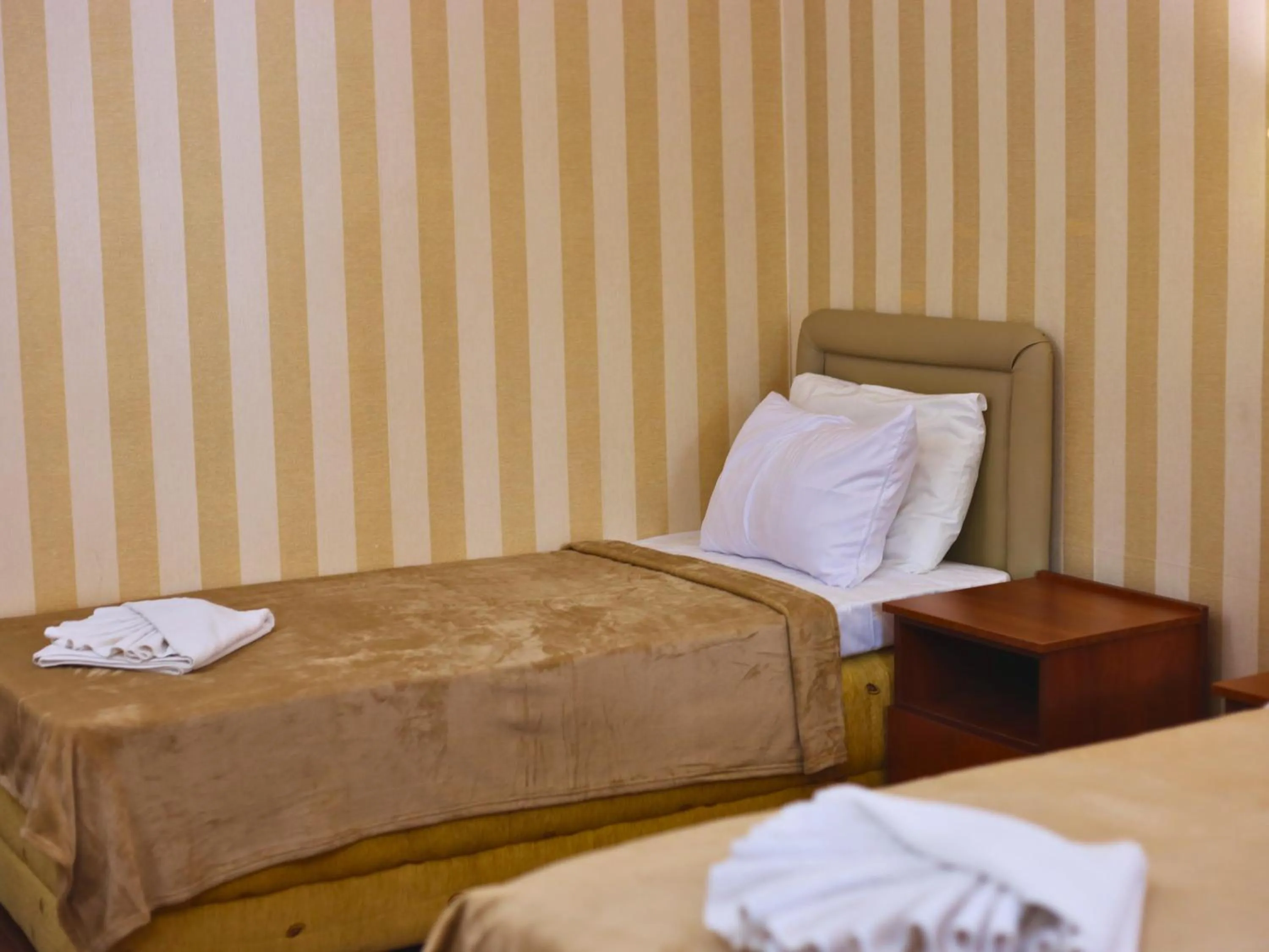 Bed in Central Hotel & Restaurant