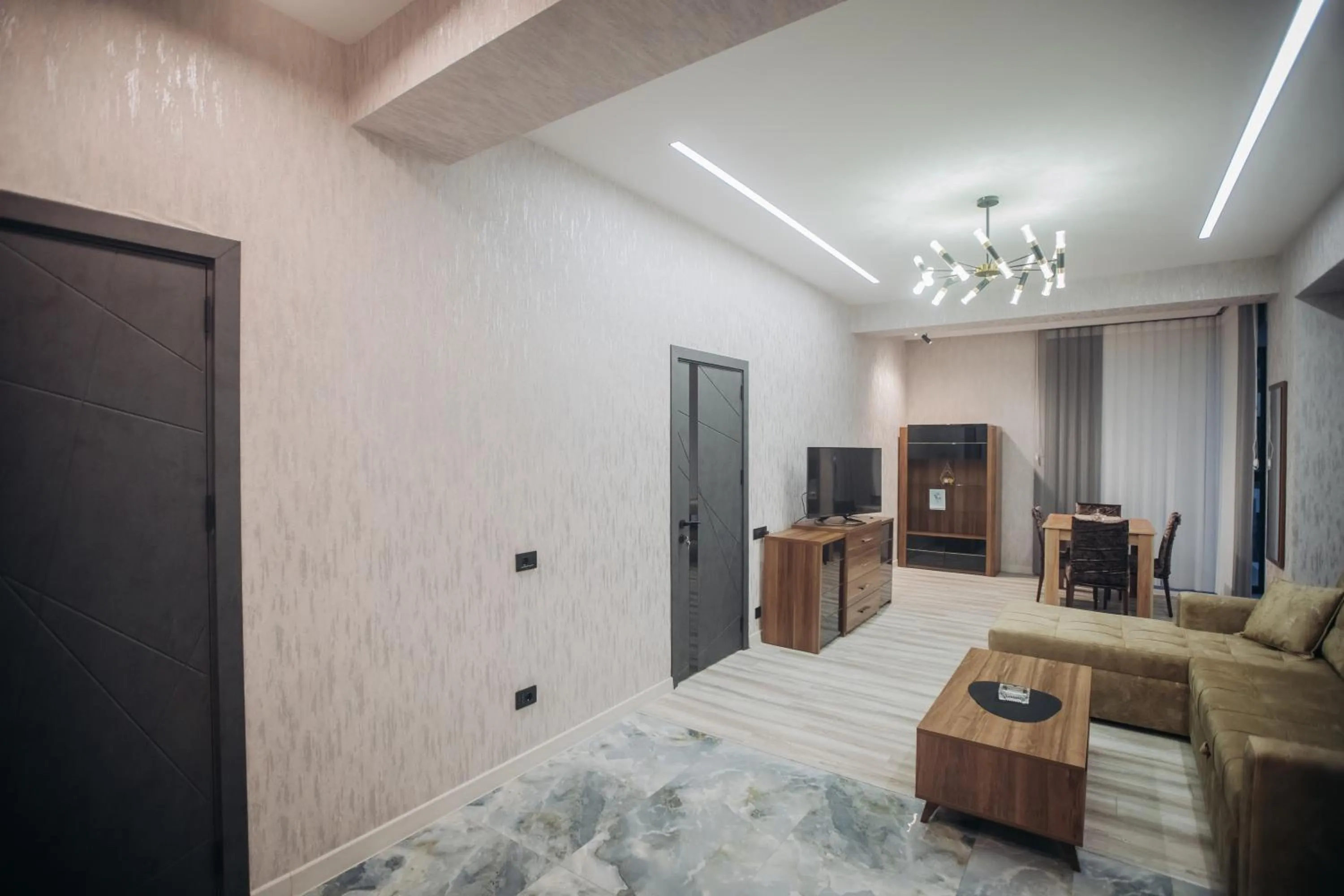 Communal lounge/ TV room in Sabah Bayil Residence Family Apart