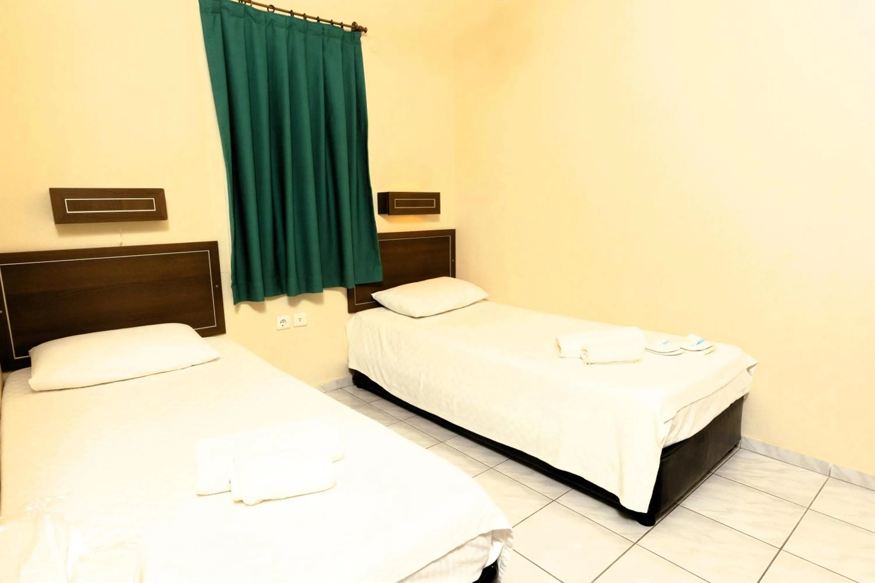 Bed in The Aegean Gate Hotel