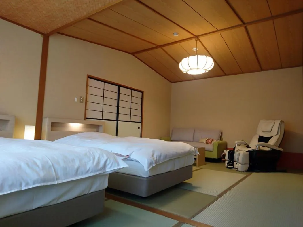 Bed in Hotel Kunitomi Suisennkaku