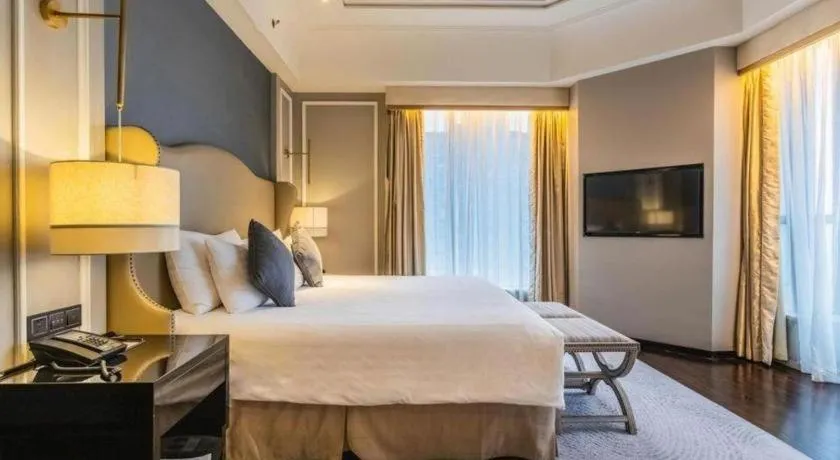 Bed in Grand New Century Hotel Yixing