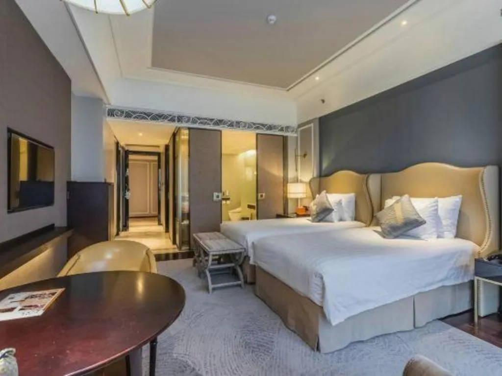 Bed in Grand New Century Hotel Yixing