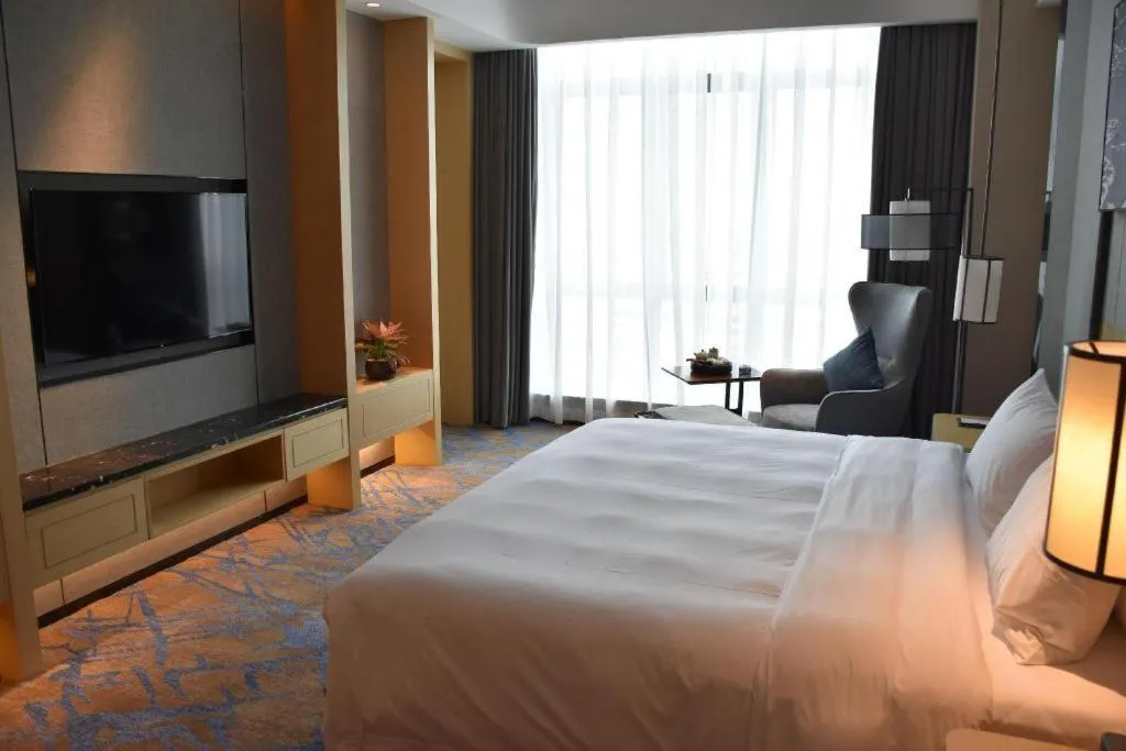 Bed in Zhuhai Tangyi Hotel