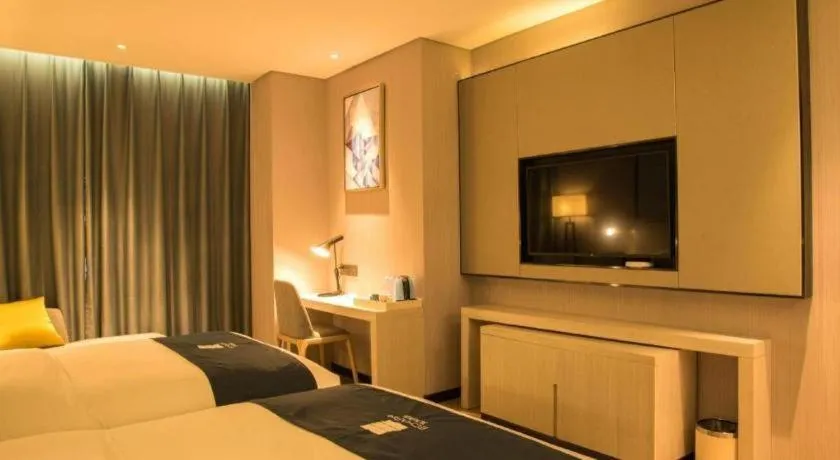 Bed in Echarm Hotel Xiantao Yuantai Weilaicheng