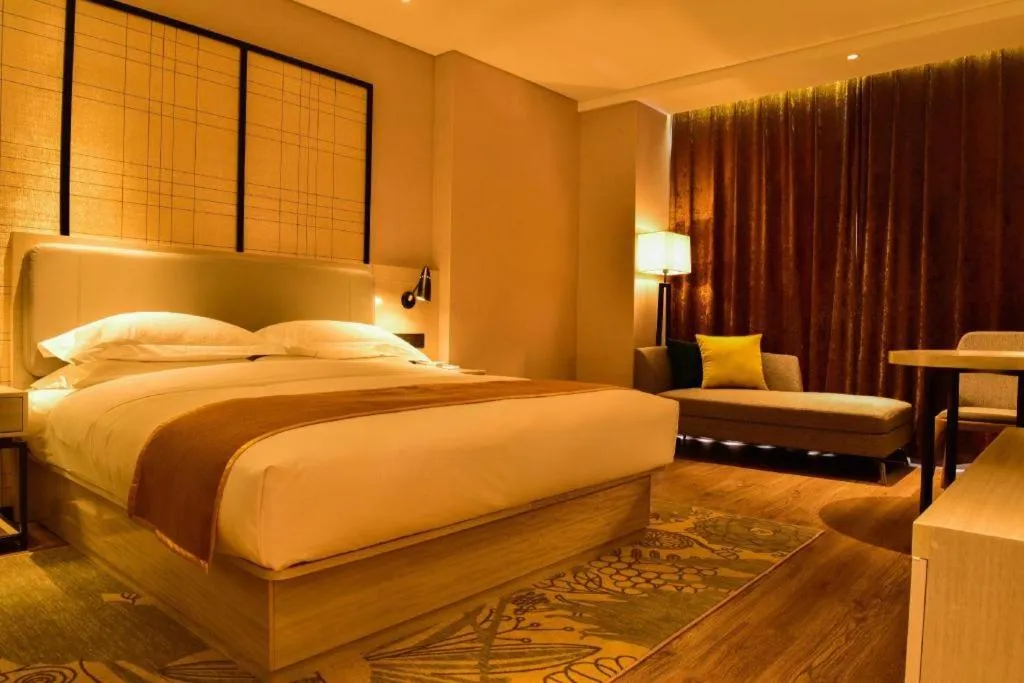 Bed in Echarm Hotel Xiantao Yuantai Weilaicheng