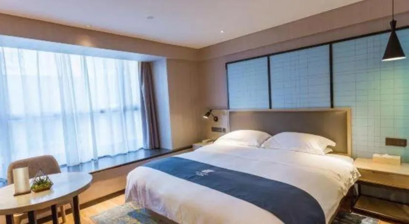 Bed in Echarm Hotel Xiantao Yuantai Weilaicheng