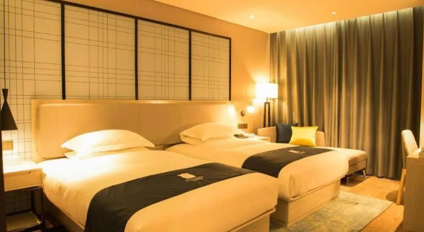 Bed in Echarm Hotel Xiantao Yuantai Weilaicheng