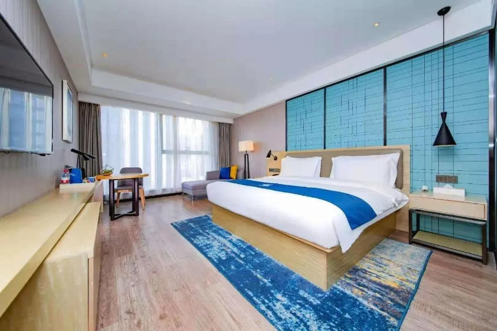 Bed in Echarm Hotel Xiantao Yuantai Weilaicheng