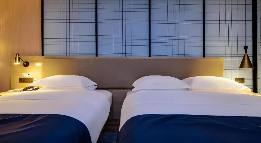 Bed in Echarm Hotel Guizhou Xingyi Jushan Avenue