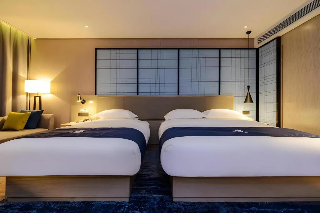 Bed in Echarm Hotel Guizhou Xingyi Jushan Avenue