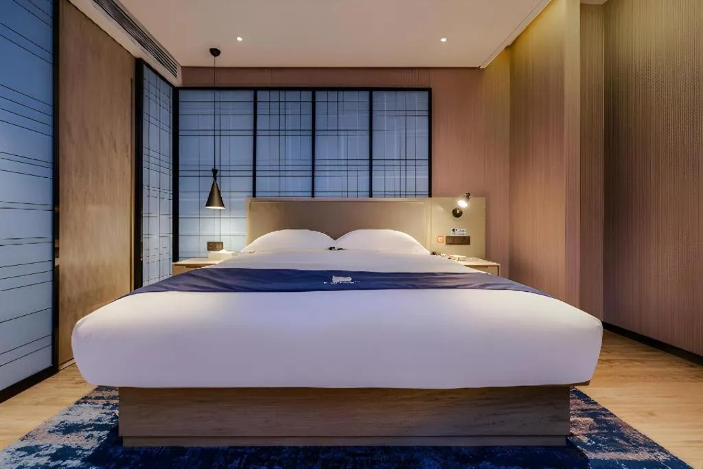 Bed in Echarm Hotel Guizhou Xingyi Jushan Avenue