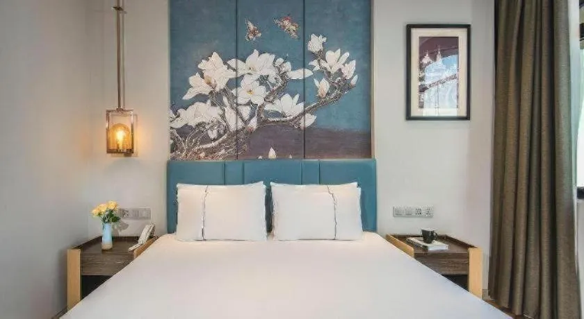 Bed in Magnotel Hotel Dongxing Guomen Port