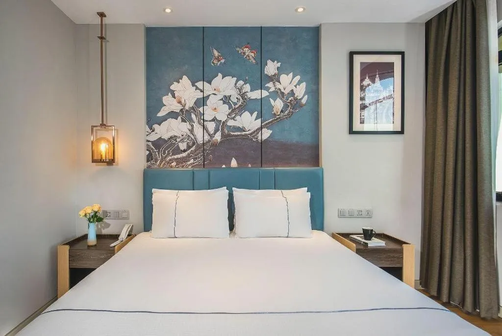 Bed in Magnotel Hotel Dongxing Guomen Port