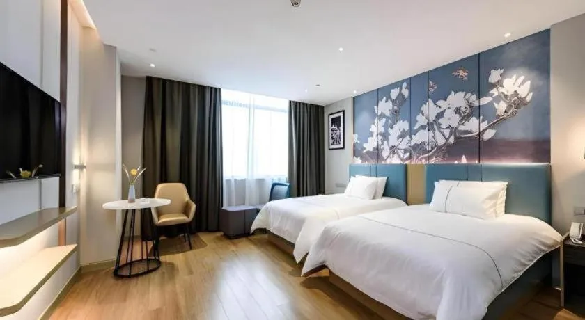 Bed in Magnotel Hotel Dongxing Guomen Port