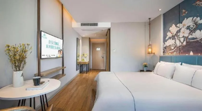 Bed in Magnotel Hotel Dongxing Guomen Port