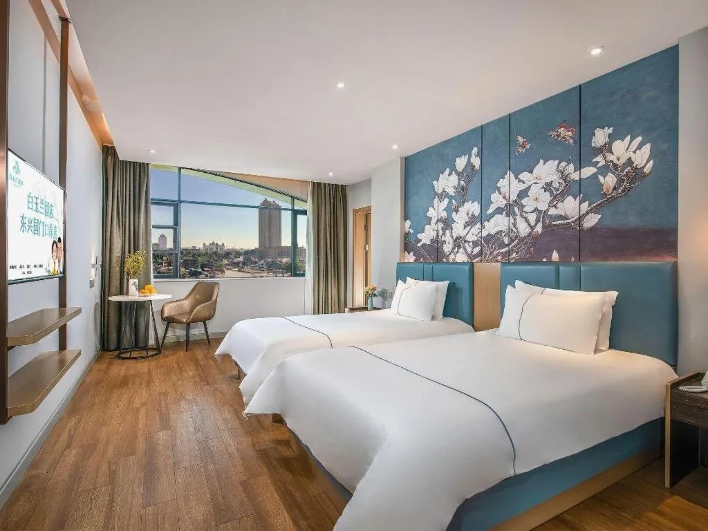 Bed in Magnotel Hotel Dongxing Guomen Port