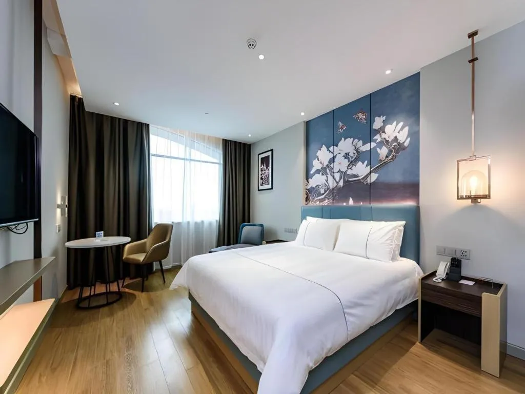 Bed in Magnotel Hotel Dongxing Guomen Port
