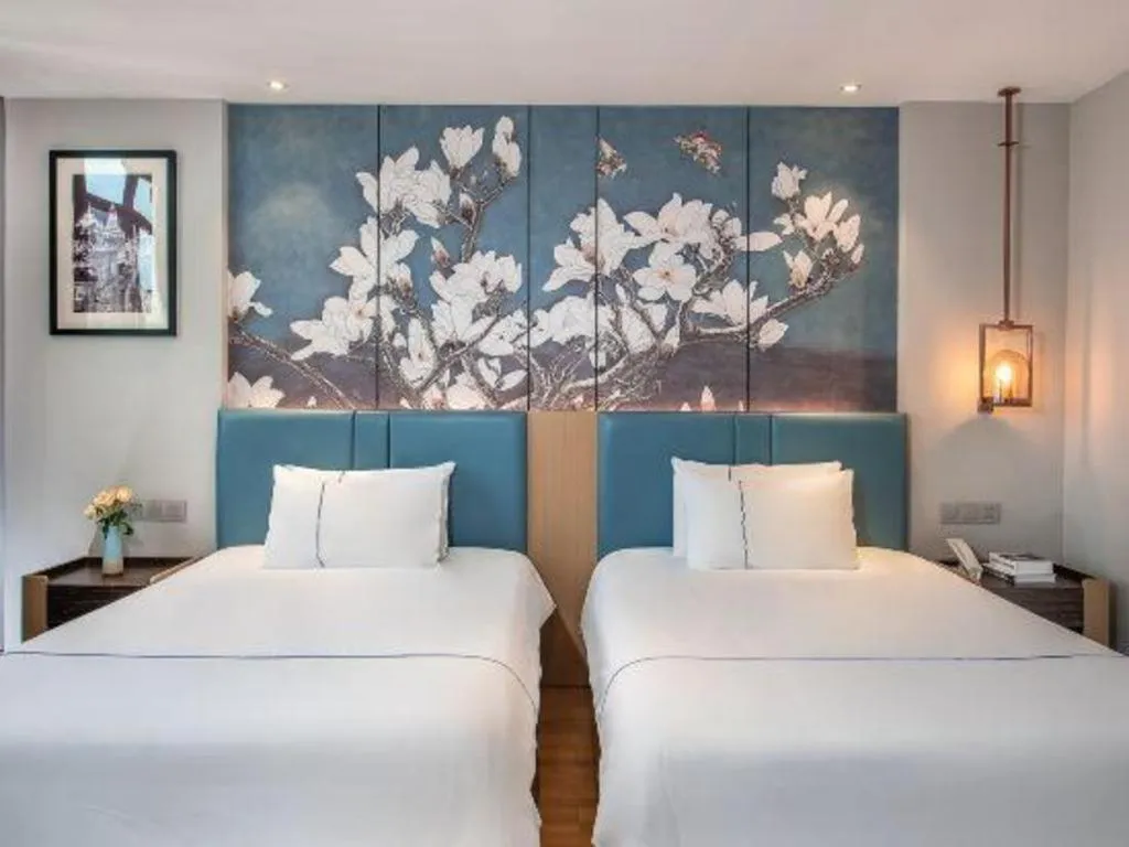 Bed in Magnotel Hotel Dongxing Guomen Port