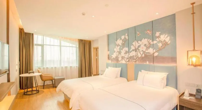 Bed in Magnotel Hotel Dongxing Guomen Port