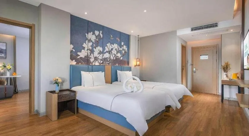 Bed in Magnotel Hotel Dongxing Guomen Port