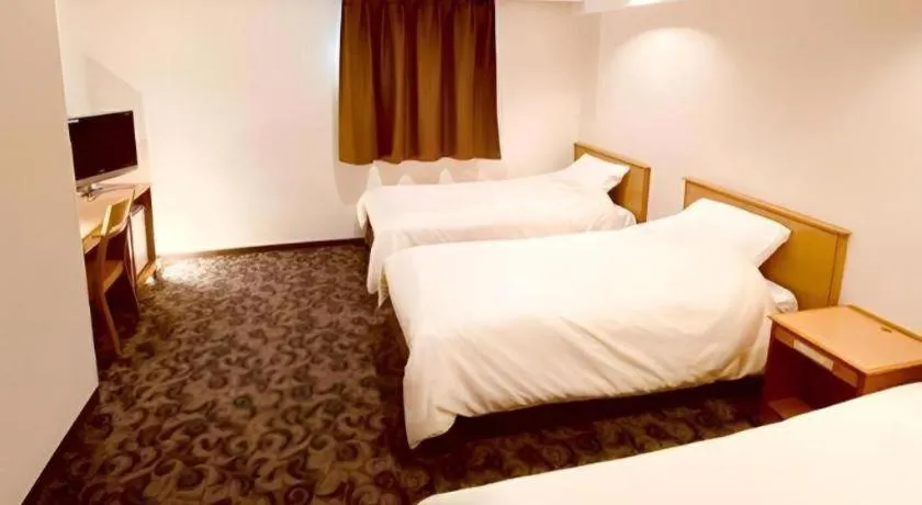 Bed in Nansei Kanko Hotel